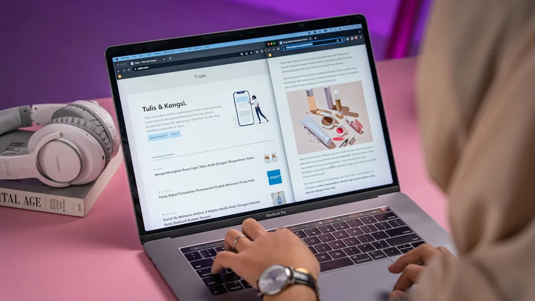 A man uses a laptop indoors to analyze stock market trends graph on screen.